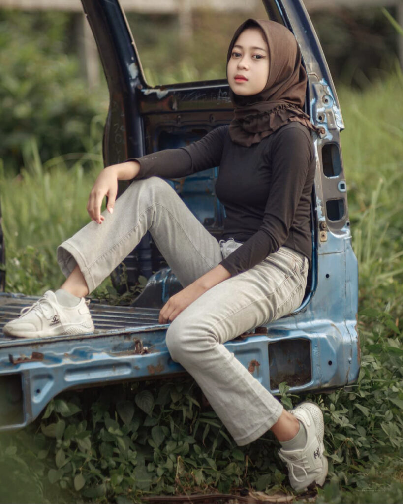 Pose duduk Nanda Frisca di atas angkot bekas rusak